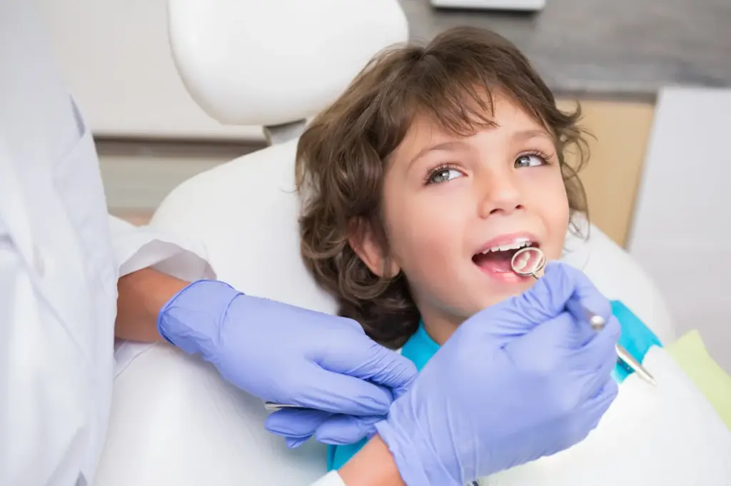 A young child smiling during a dental checkup