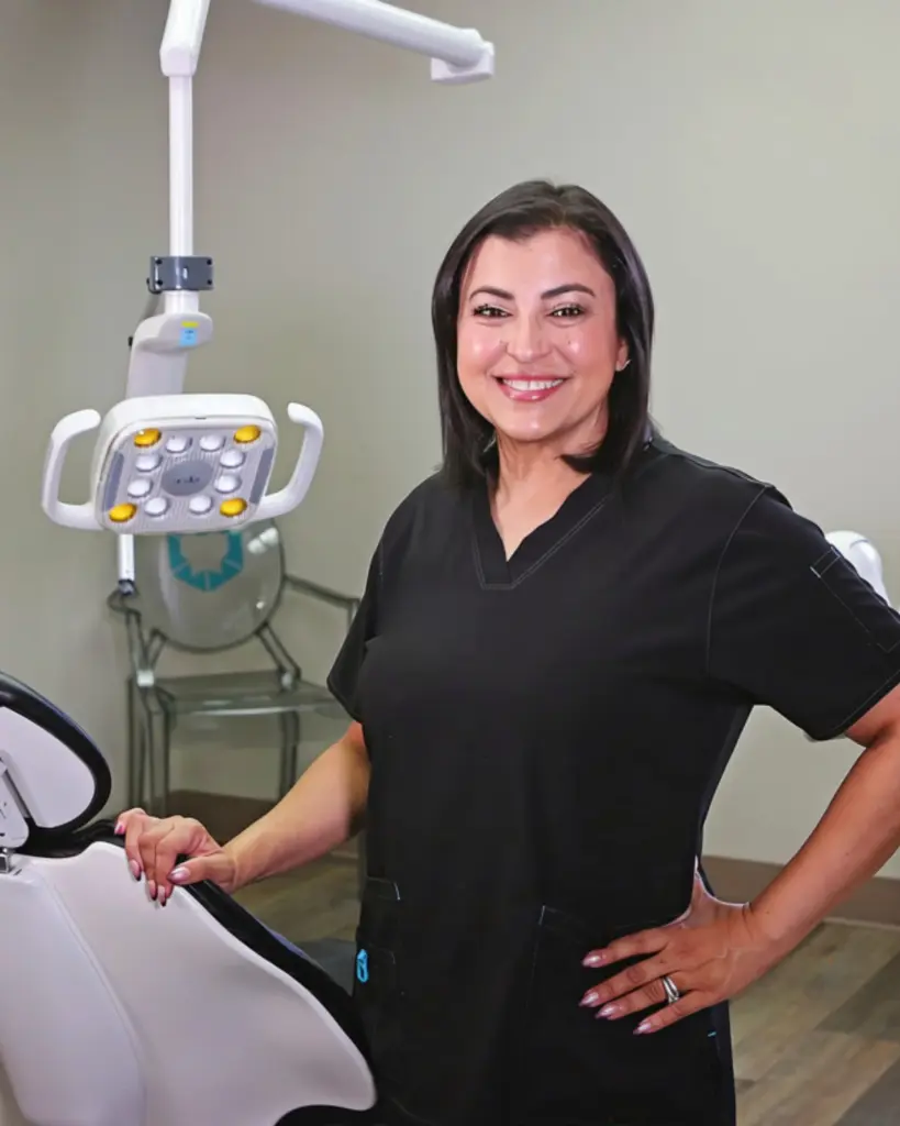 Dr. Mariam Hanna, DDS standing beside a treatment chair at Diamond Dental in Tulsa