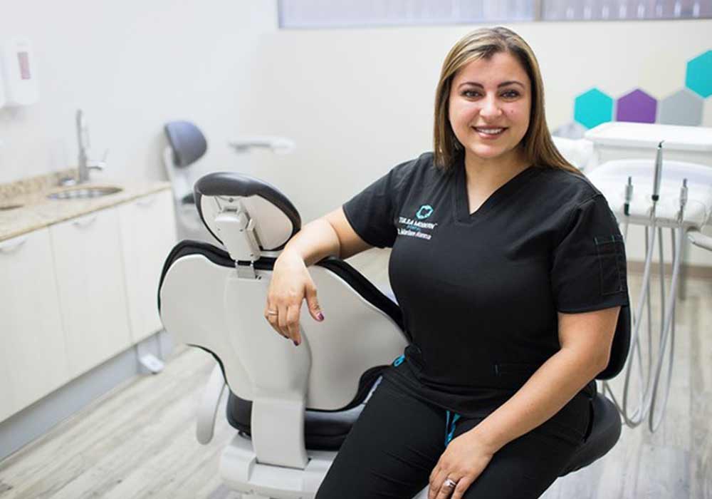 Dr. Mariam Hanna, DDS beside a treatment chair at Diamond Dental in Tulsa